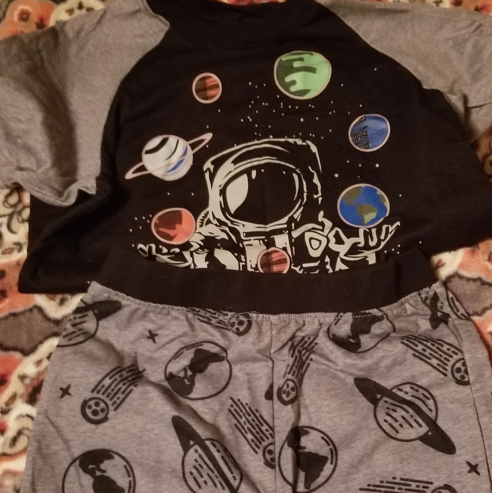 Short sleeve & shorts pajama set. The planets on shirt *only* glow in the dark!